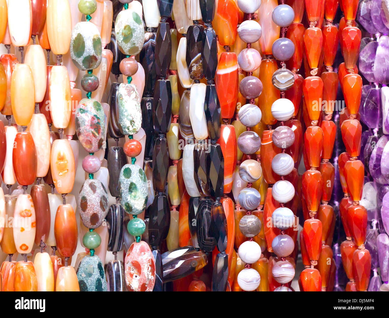 multi-colored beads of various sizes and shapes on the wall Stock Photo