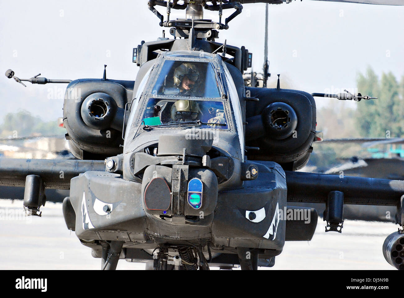 A US Army AH-64 Apache attack helicopter taxis down the flight line after returning from a mission October 11, 2013 in Jalalabad, Afghanistan. Stock Photo