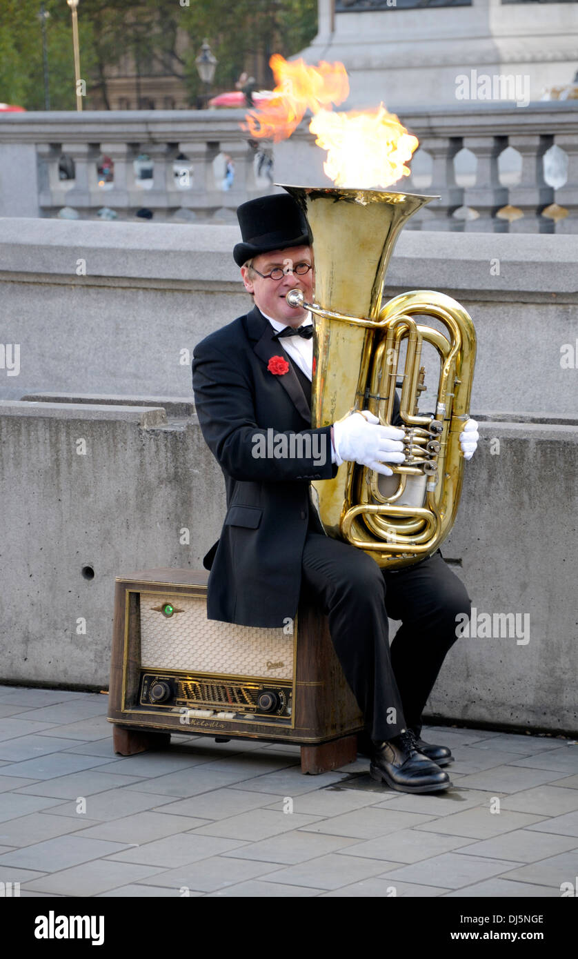 London, England, UK. Busker in Trafalgar Square - playing tuba which emits flames Stock Photo