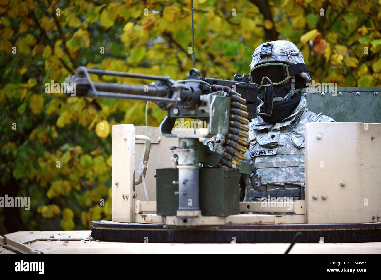 A US Soldier scans the terrain from the turret of a Humvee during reconnaissance training at the Joint Multinational Training Command's Grafenwoehr Training Area October 16, 2013 in Grafenwoehr, Germany. Stock Photo