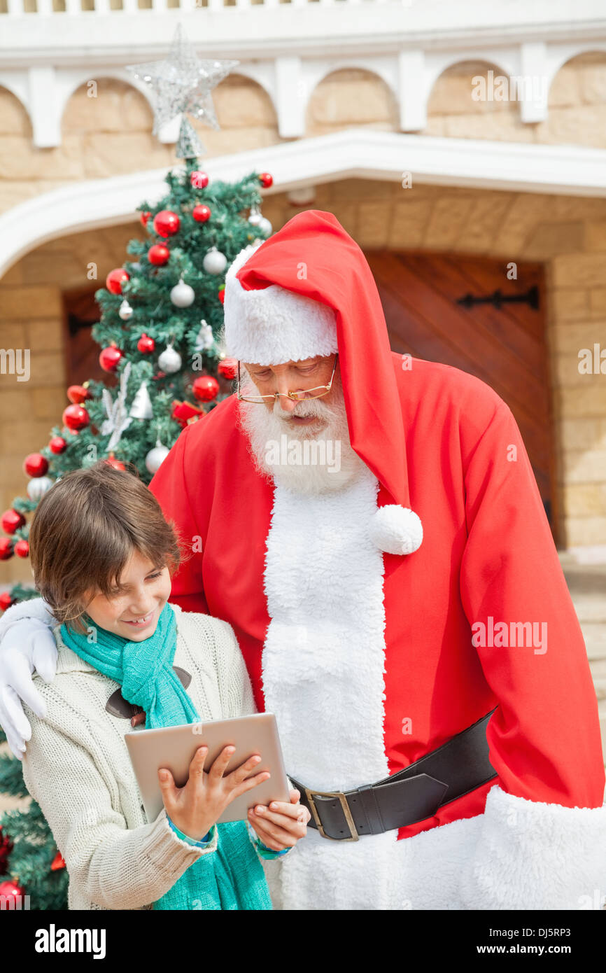 Santa Claus And Boy Using Digital Tablet Stock Photo - Alamy
