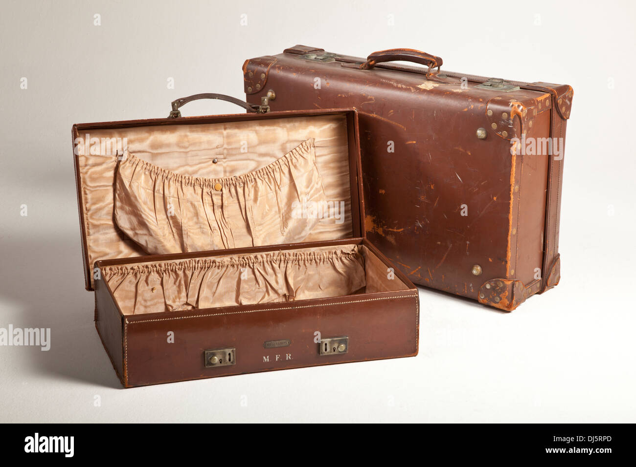 Very old leather suitcases, marks where travel labels have been