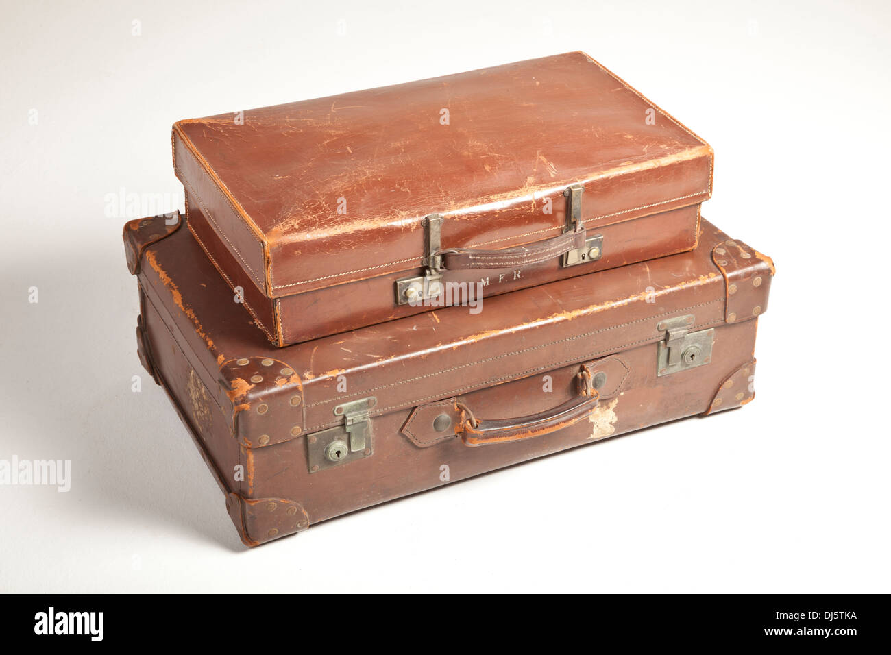 Very old leather suitcases, marks where travel labels have been attached. Stock Photo