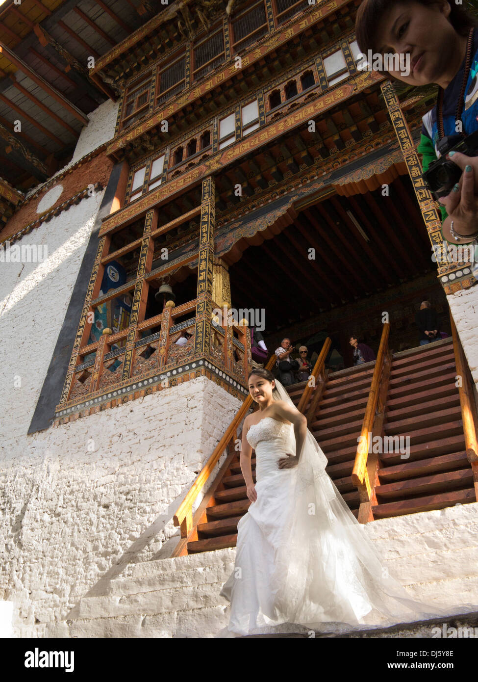 Bhutan, Punakha Dzong, Chinese woman in wedding dress posing for bridal portraits Stock Photo