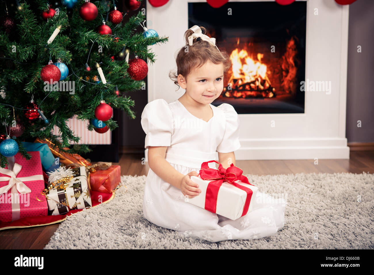 a little girl with Christmas Tree decoration Stock Photo