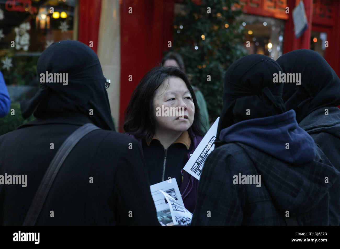 London, UK. 22nd November 2013. Burqua clad women at Anjem Choudary's Islamic Roadshow talk to local woman at protest to stop the Chinese oppression Against the Muslims of Xinjiang, Gerrard Street, London, UK, 22 November 2013 Credit:  martyn wheatley/Alamy Live News Stock Photo