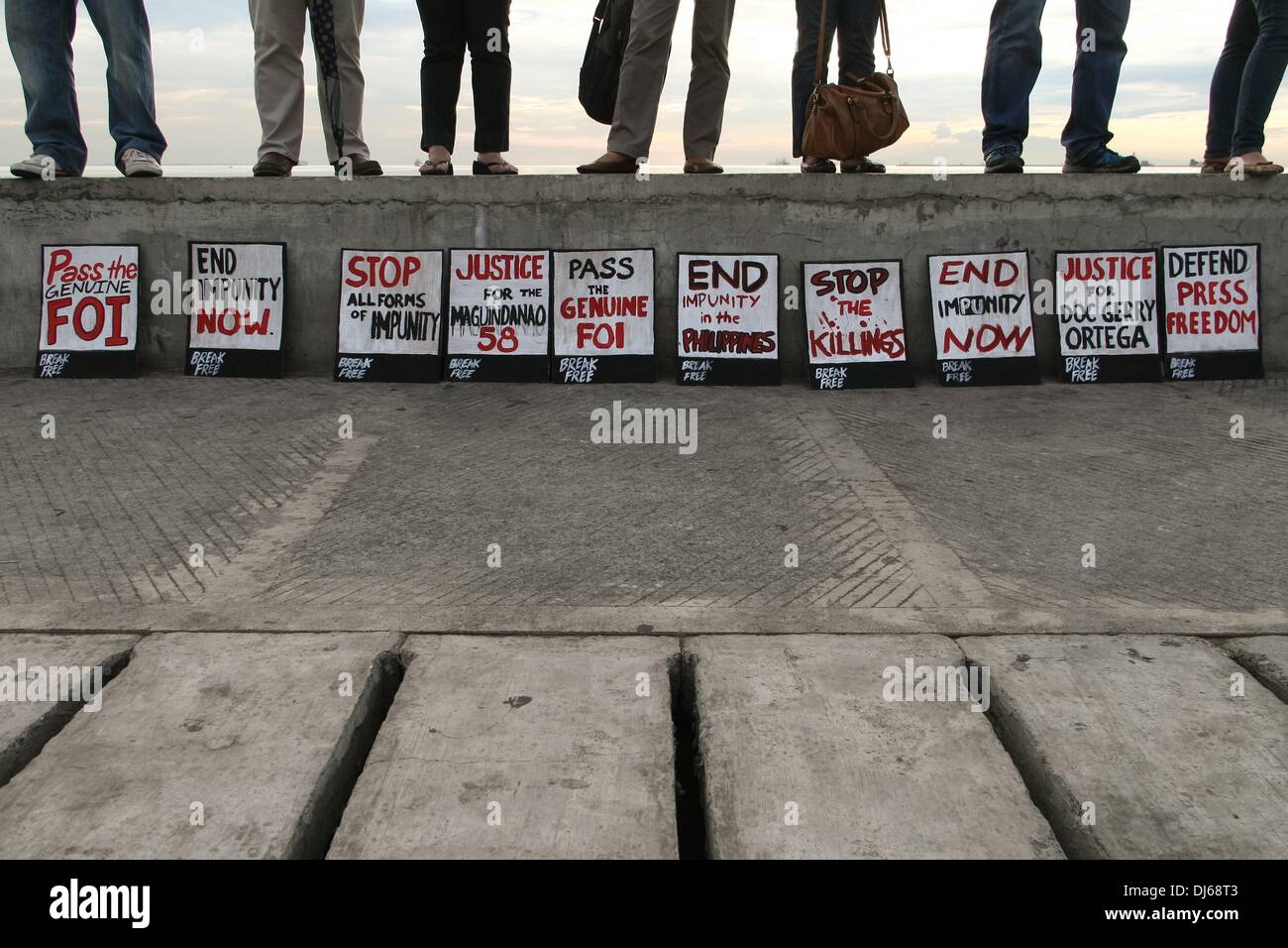Manila, Philippines. 22nd Nov, 2013. Posters on display at the human chain event at the Baywalk in Roxas Boulevard in Manila. -- Members of different media organizations held a human chain and candle lighting ceremony for the 34 journalists killed four years ago. 58 individuals were killed and buried in Maguindanao in one of the worst election related violence in the country.Photo: J Gerard Seguia/NurPhoto Credit:  J Gerard Seguia/NurPhoto/ZUMAPRESS.com/Alamy Live News Stock Photo