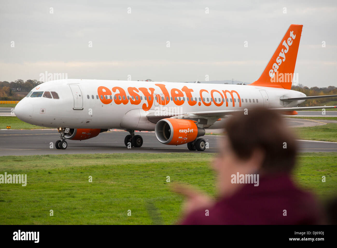 An Easyjet plane taxiing towards the runway at Manchester Airport, UK ...