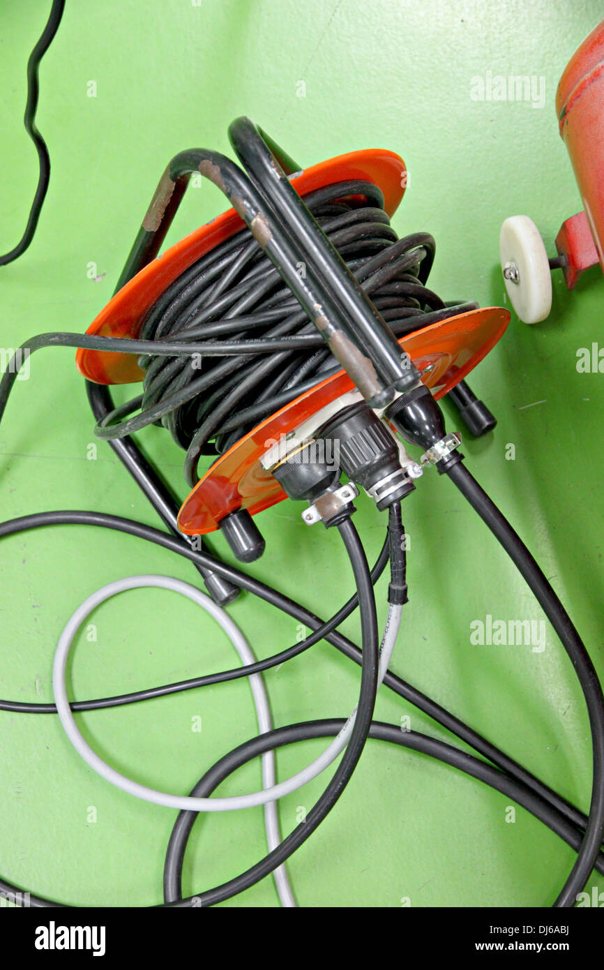Power cable from the electrical socket outlet in Industrial factory. Stock Photo