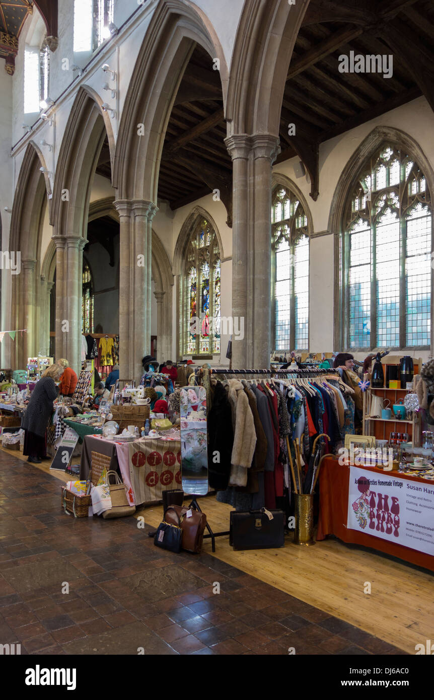 Deconsecrated church stallholders and visitors at a craft fair inside St Peter's church in