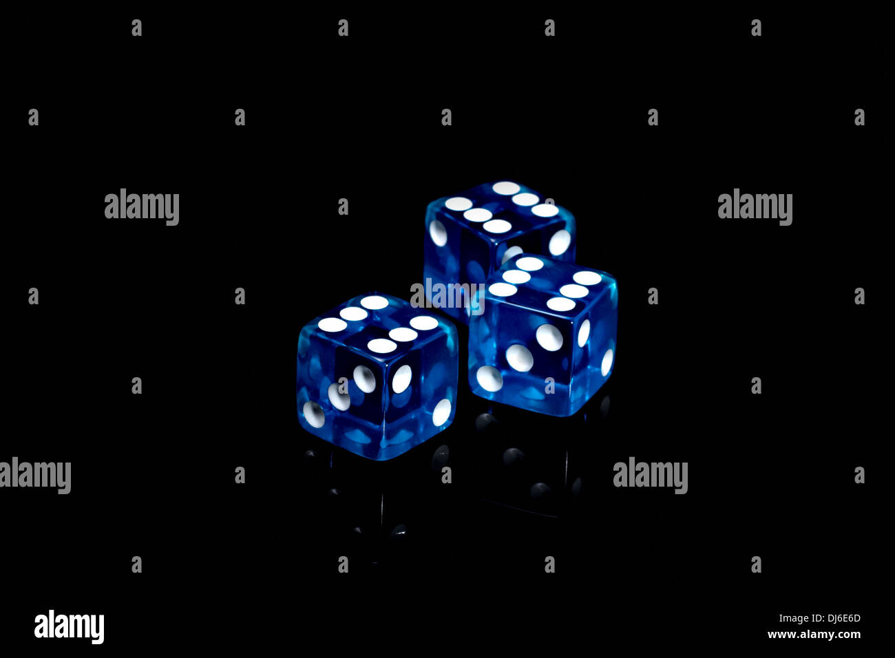 Three blue casino dice on a black background Stock Photo