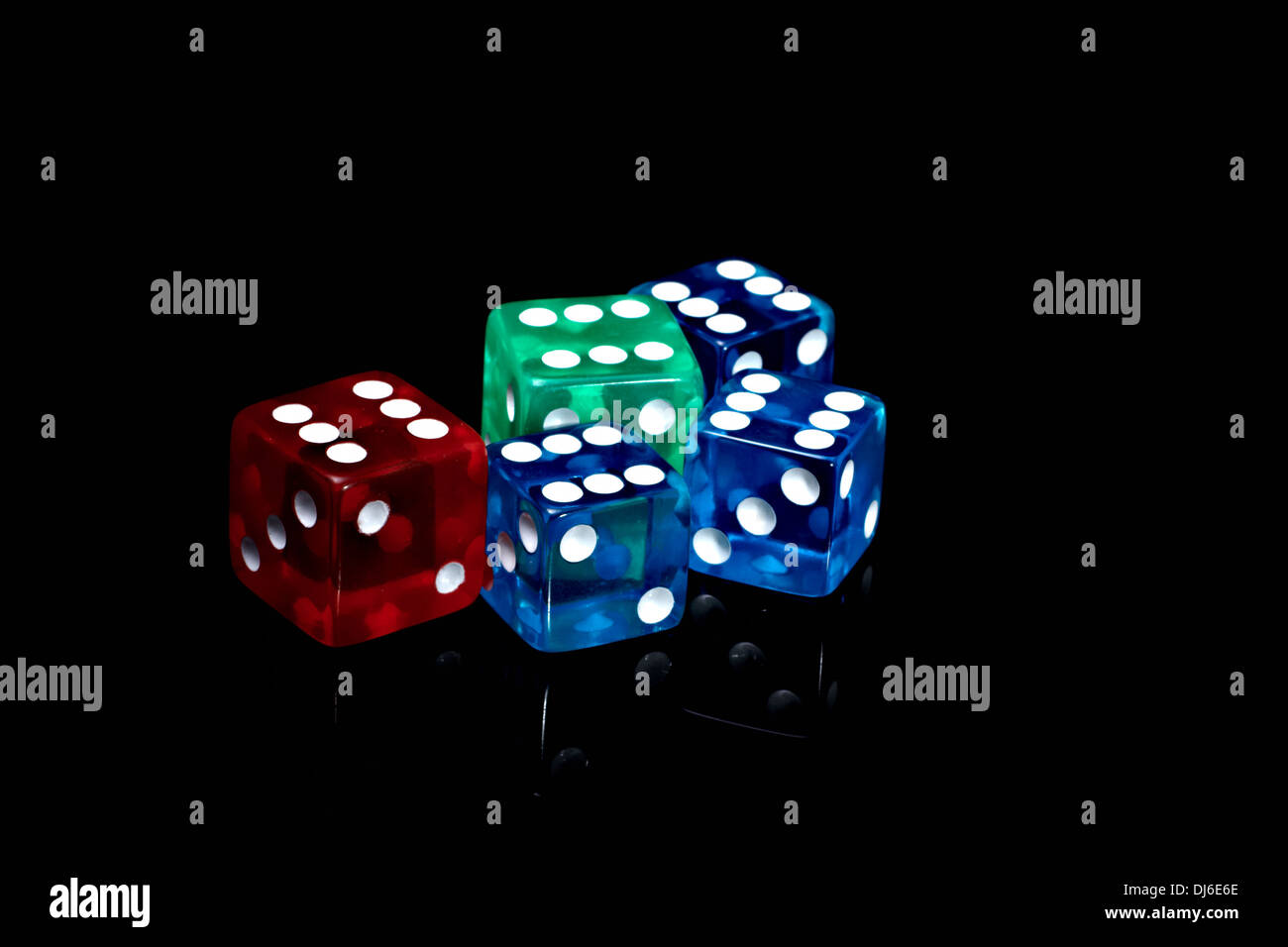 Five colour casino dice on a black background Stock Photo