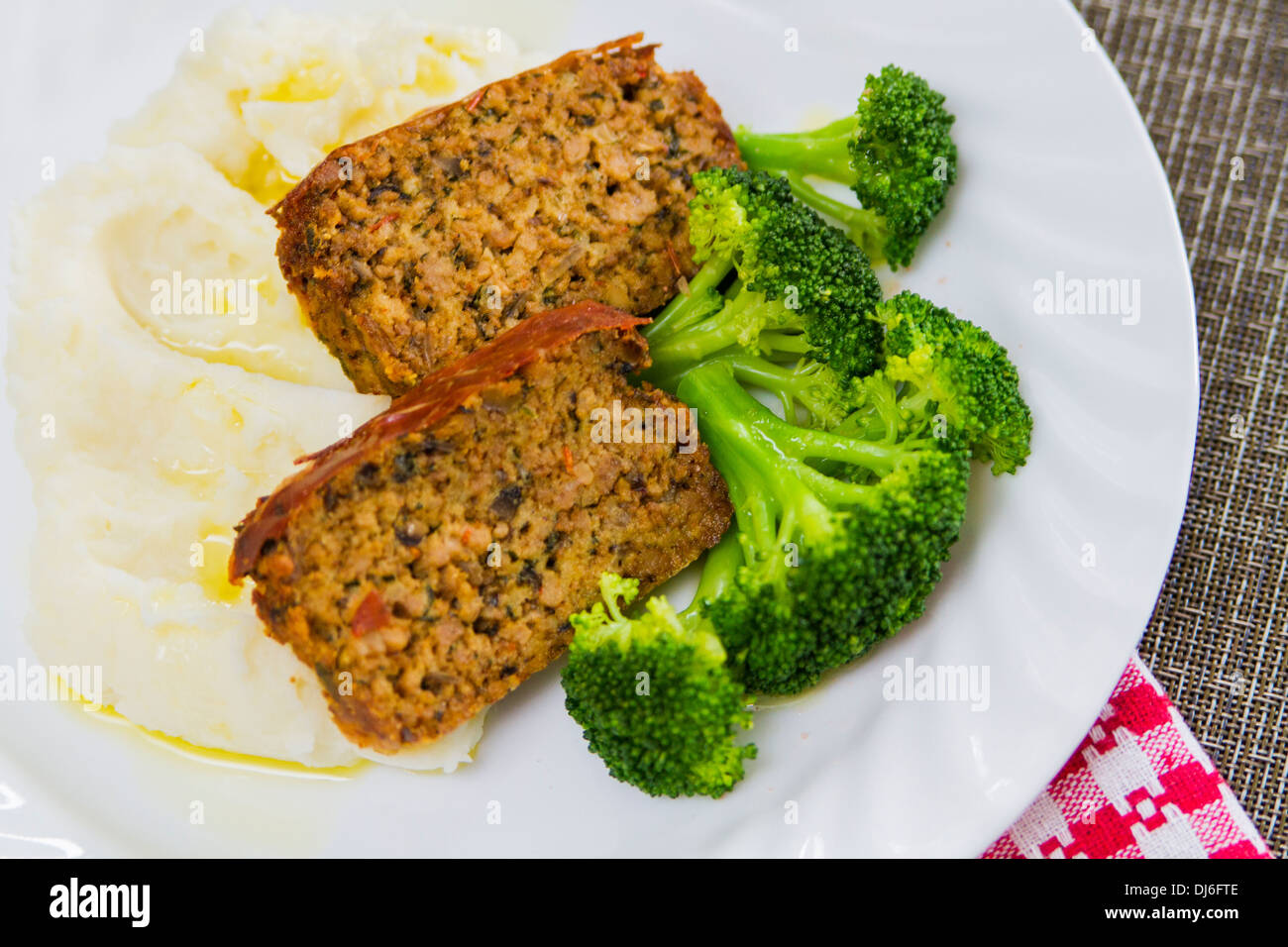 Freshly baked home style pork meatloaf with mashed potatoes and