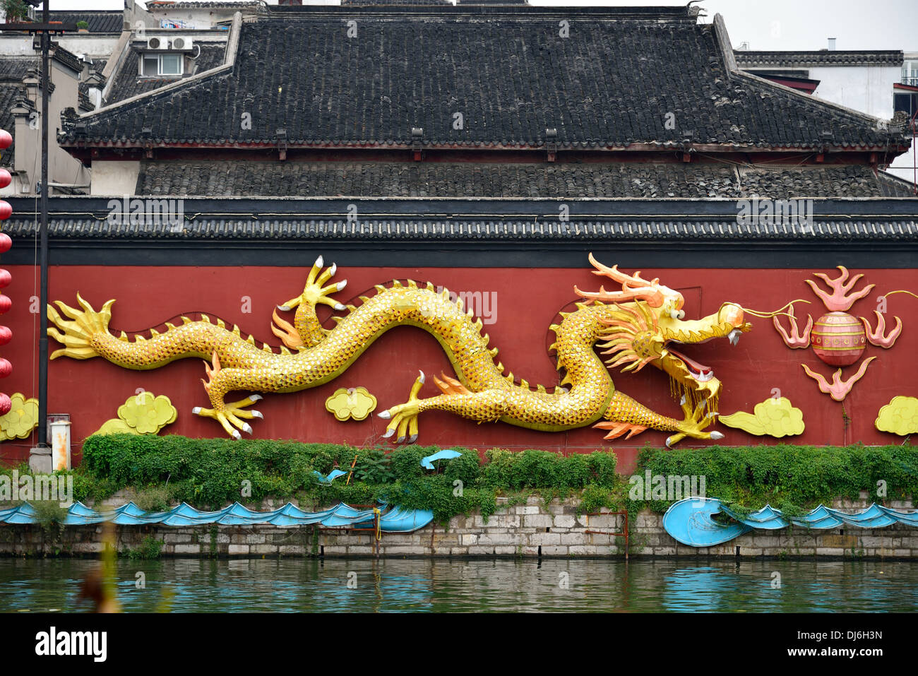 Golden dragon on a red wall by the Qinhuai River. Nanjing, Jiangsu Province, China. Stock Photo
