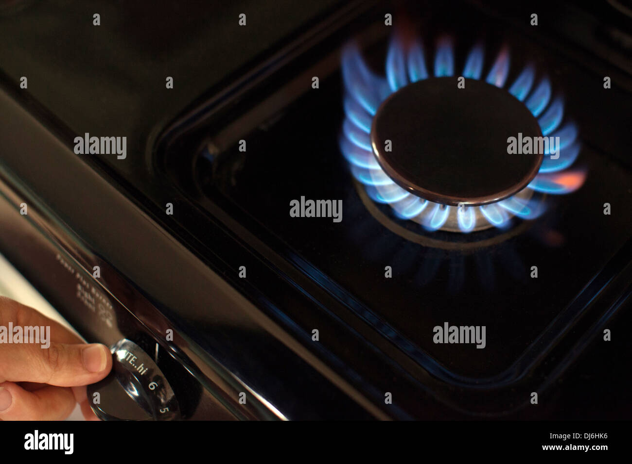 Turning on the gas on a stove top gas cooker Stock Photo Alamy