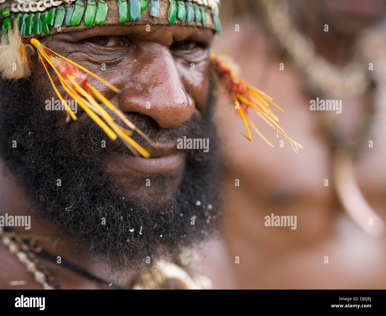 Beared tribal man with beetle wing casing headband at Goroka Show tribal singsing festival, Papua New Guinea Stock Photo