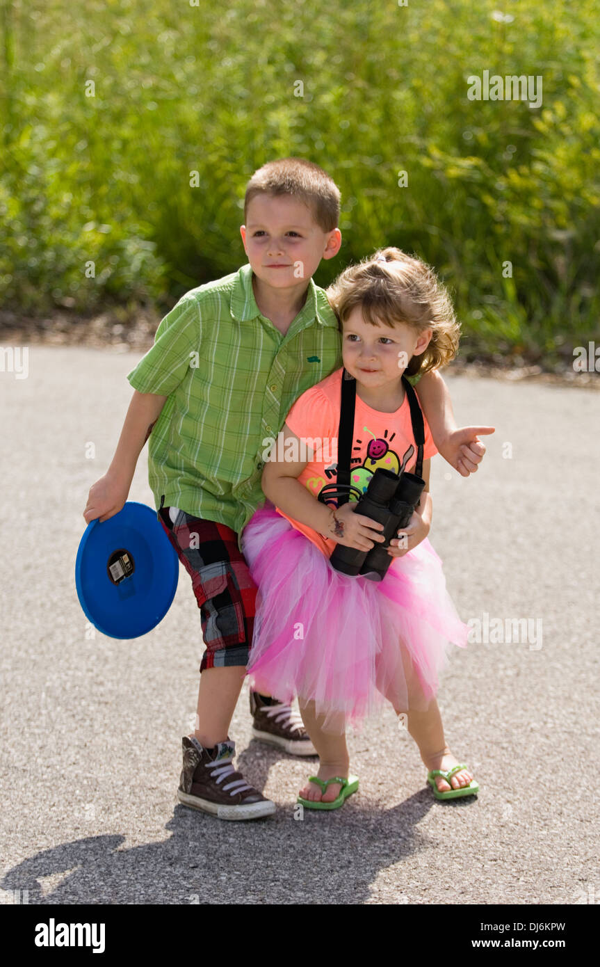 Five Year Old Brother and Three Year Old Sister Posing for Camera Stock Photo