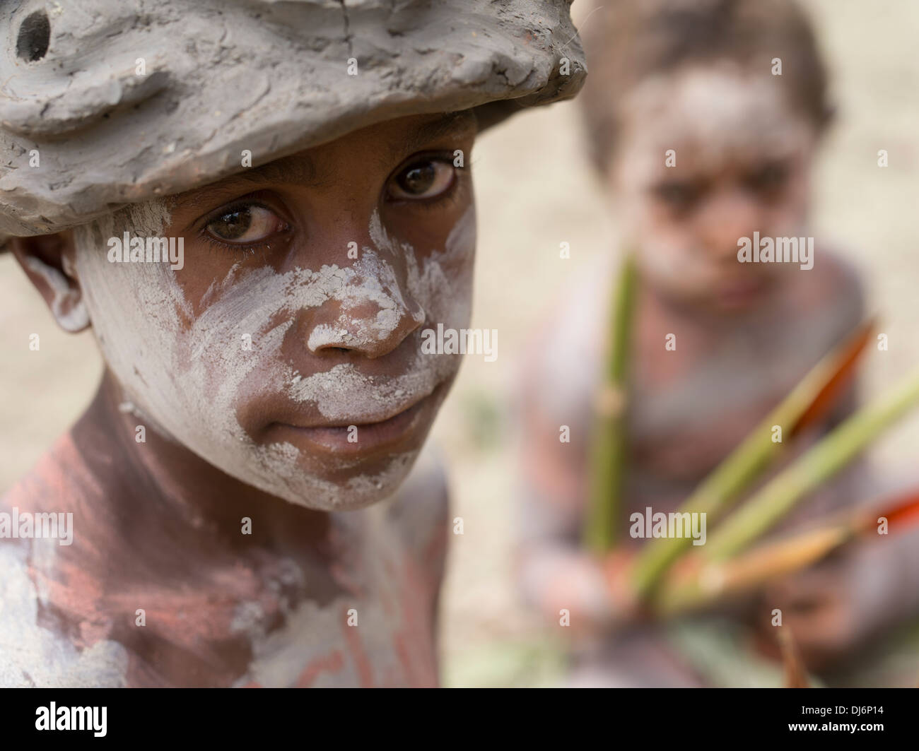 Papua new guinea mud child children face paint on with hires stock
