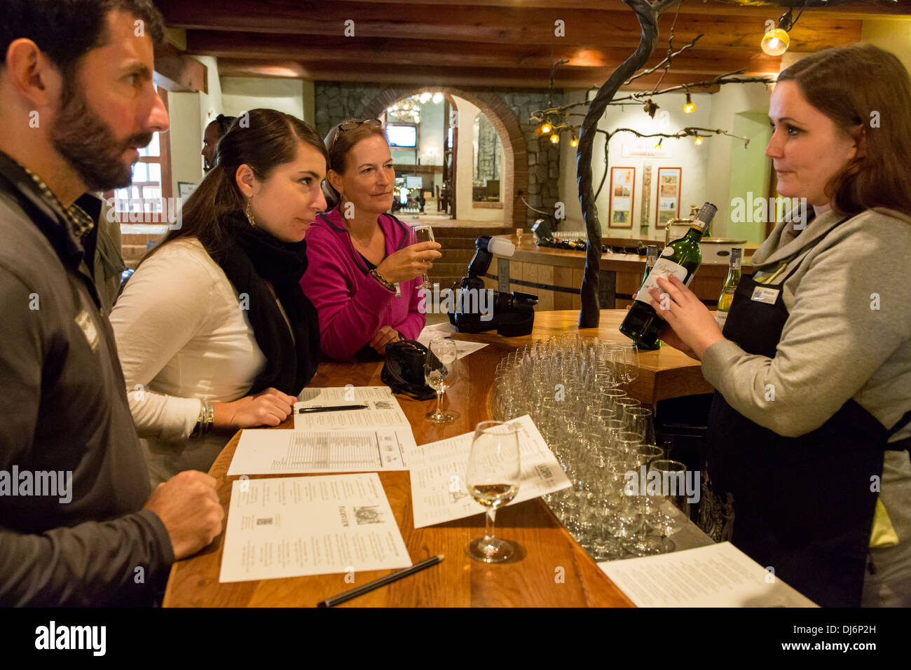 South Africa, Paarl area, near Cape Town. Tourists enjoying a wine-tasting session at Fairview winery. Stock Photo