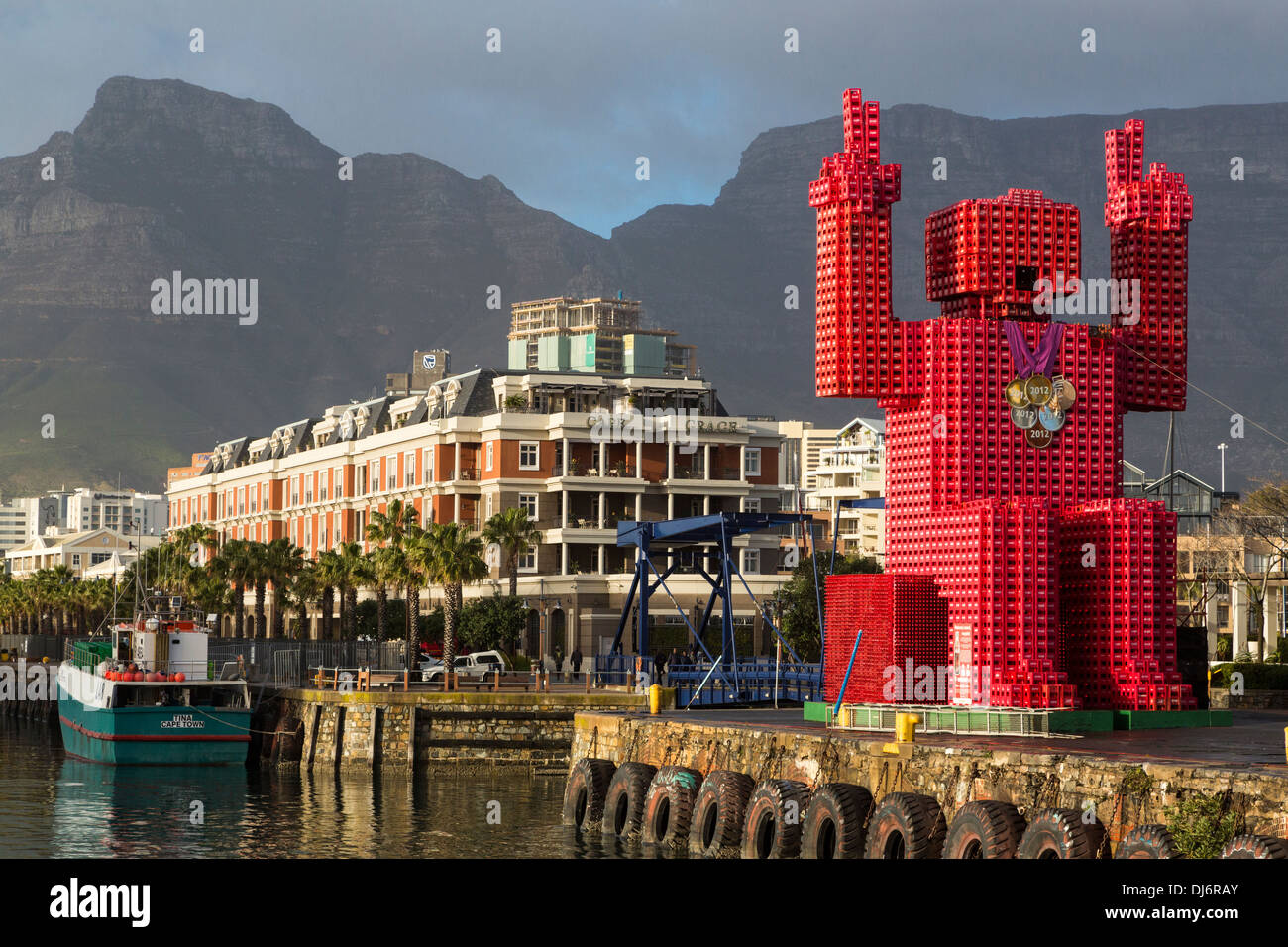 South Africa, Cape Town. 'Lego Man' sculpture made of 4200 plastic Coca Cola crates. Stock Photo