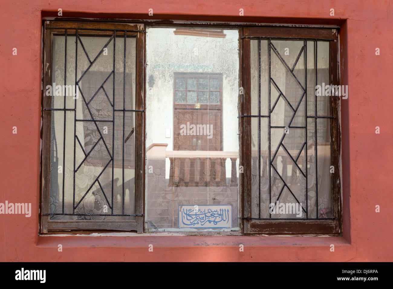 South Africa, Cape Town, Bo-kaap. Reflection in Window, Arabic Inscription at Bottom. Stock Photo