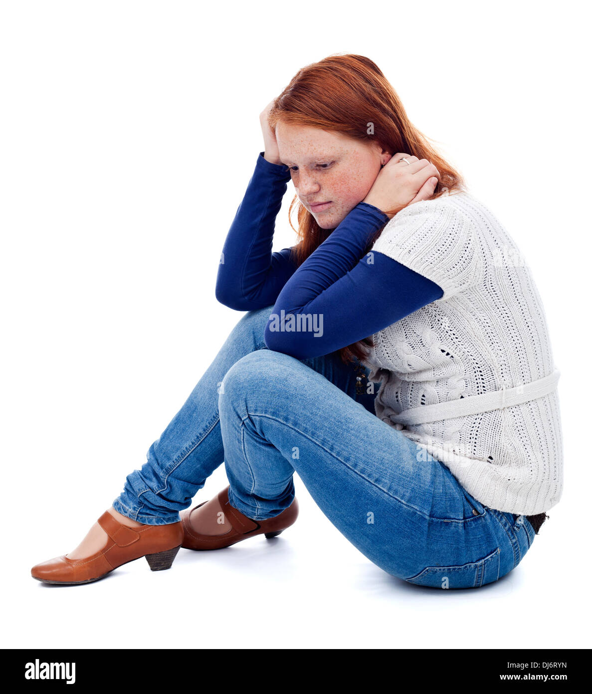 Sad young girl sitting on the floor thinking - isolated Stock Photo - Alamy