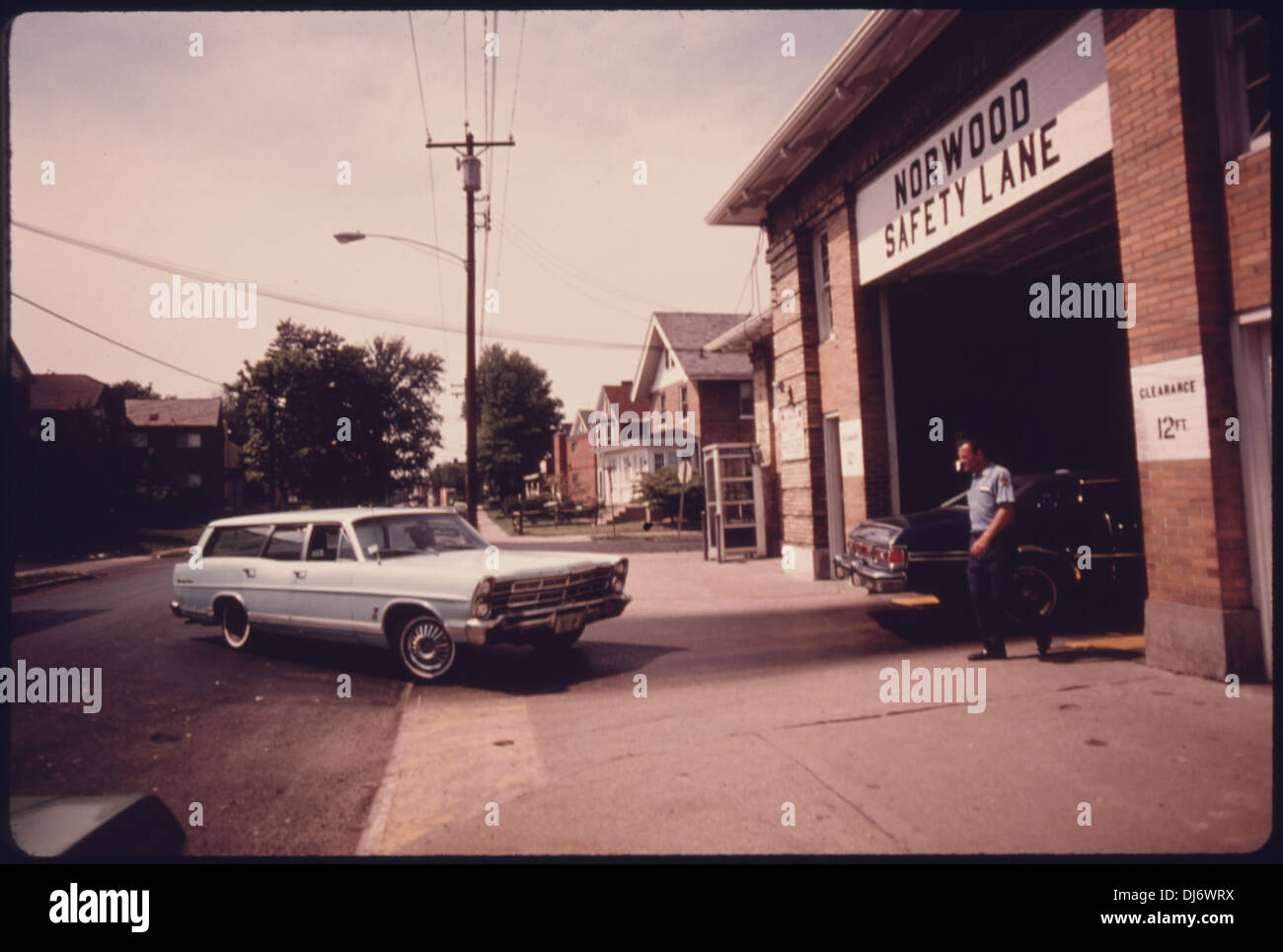 CAR ENTERS THE SAFETY LANE AT THE NORWOOD, OHIO, AUTO EMISSION INSPECTION STATION. LOCATED IN A