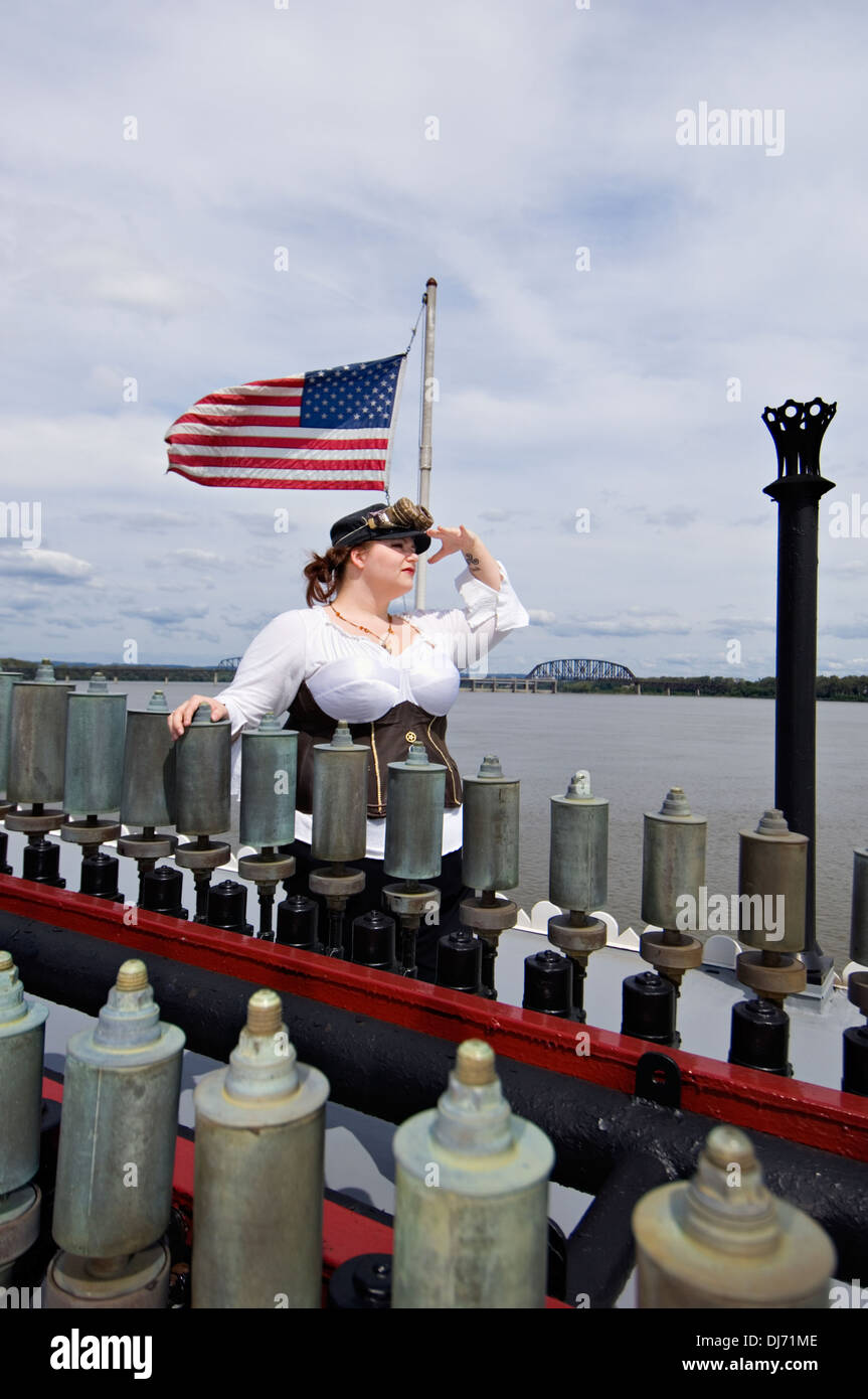 Young Woman Dressed in Steampunk Posing Behind Calliope Whistles on the Belle of Louisville Stock Photo