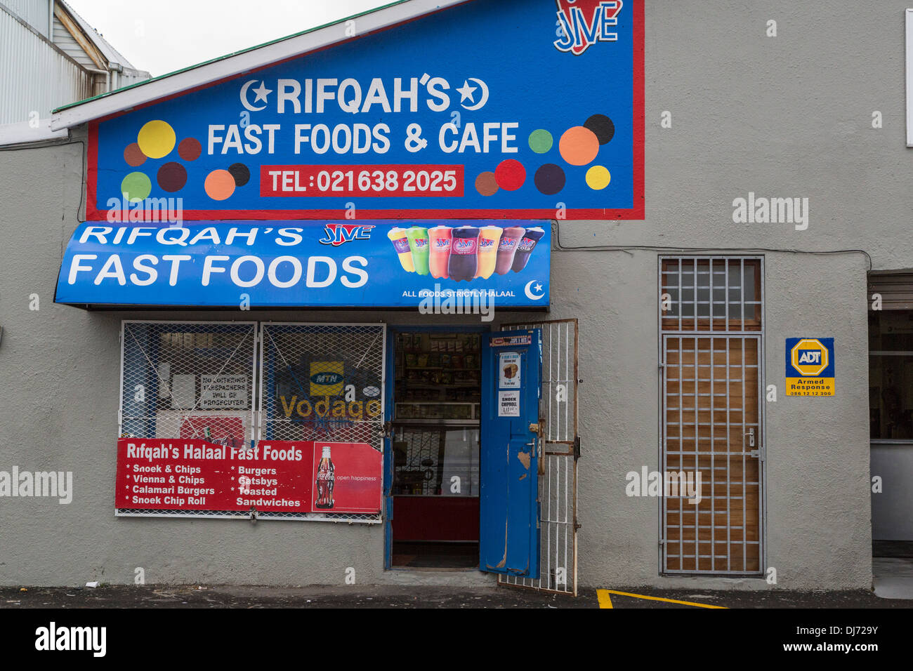 South Africa, Cape Town. Fast Food Store Offering Halaal (Islamic-approved) Food and Snacks. Note Metal Security Gates. Stock Photo