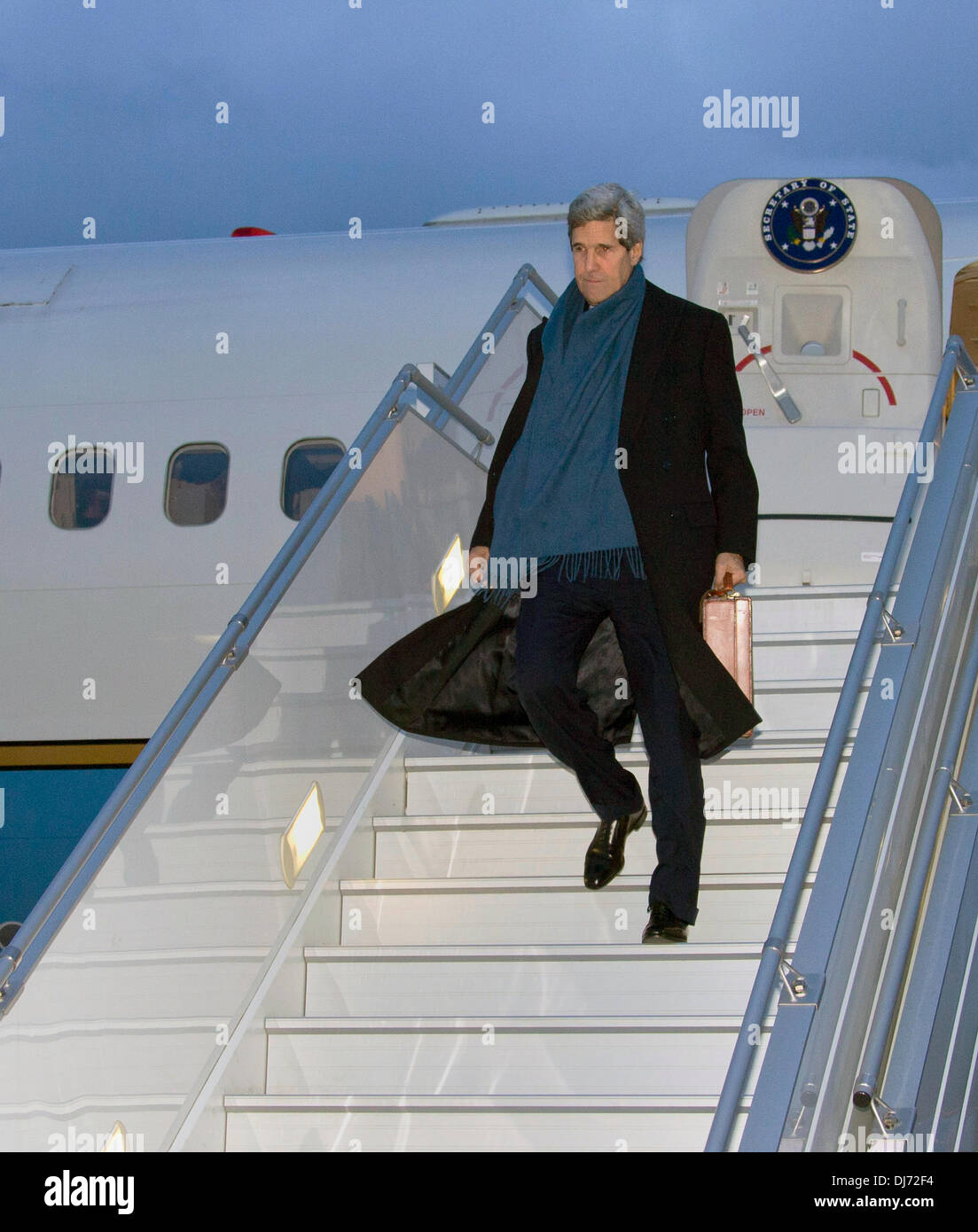 US Secretary of State John Kerry walks from the airplane to an awaiting vehicle after arriving to continue talks on Iran November 23, 2013 in Geneva, Switzerland. Stock Photo