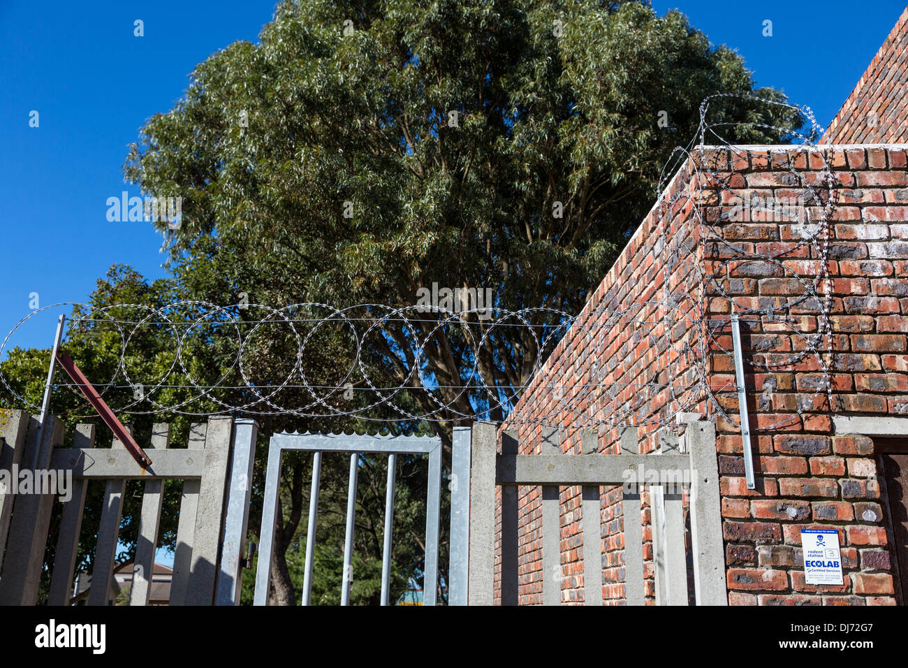 South Africa, Cape Town. Razor Wire and Metal Spikes Guard a Small Charity's Warehouse from