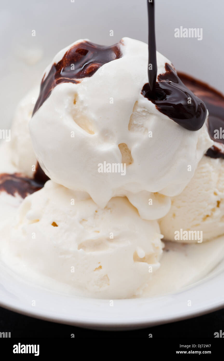 Vanilla ice cream balls with chocolate sauce. Stock Photo