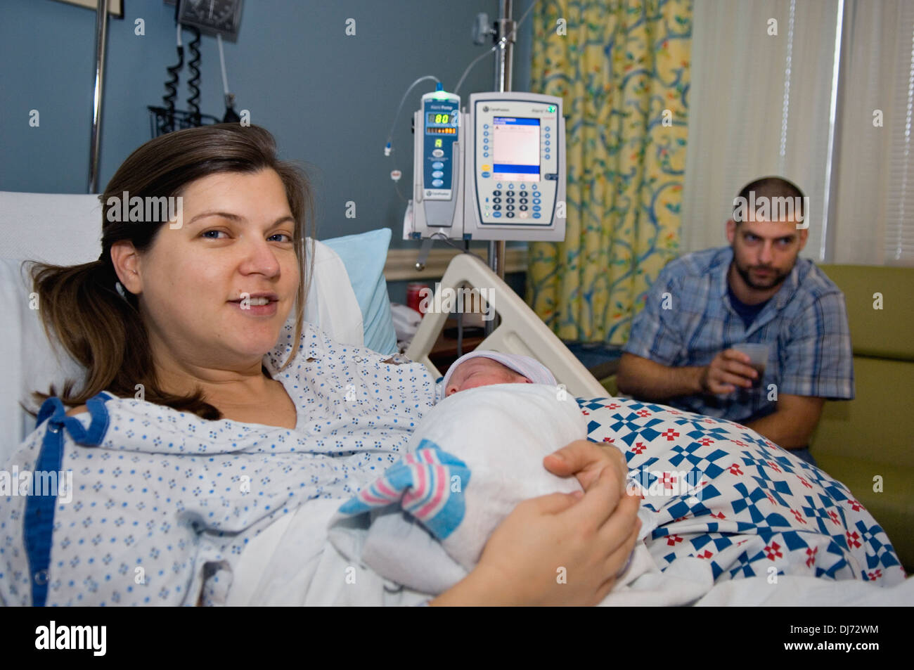 Woman Holding Her Newborn Baby in the Hospital Stock Photo