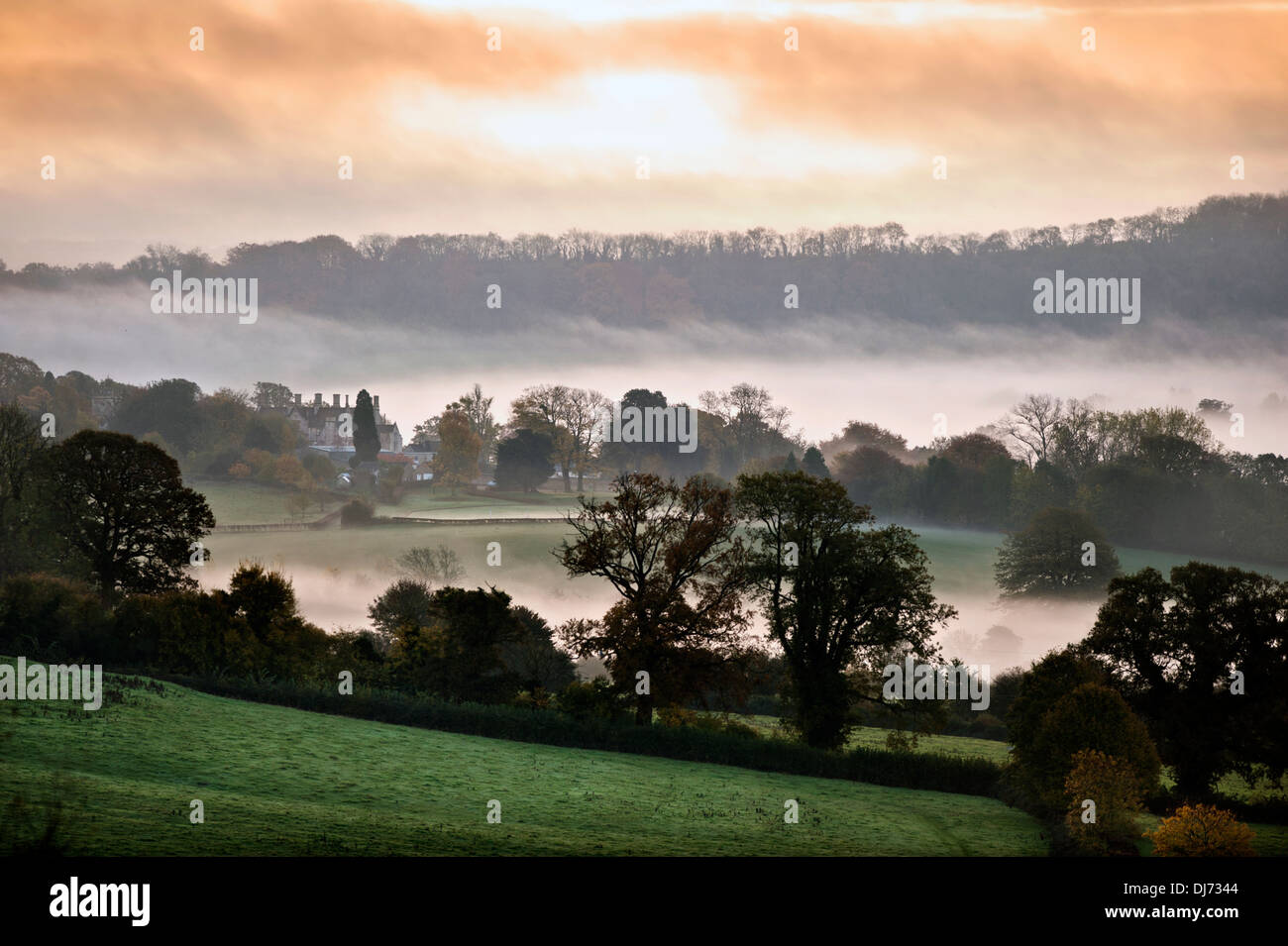 A misty dawn view of Alderley House near Wotton-under-Edge, Gloucestershire UK Stock Photo