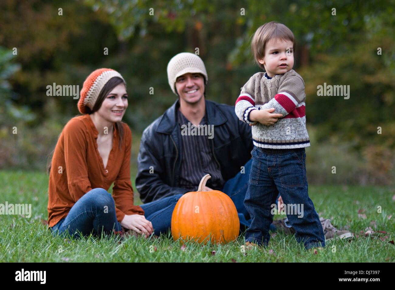 Young Family Outdoors with Pumpkin Stock Photo