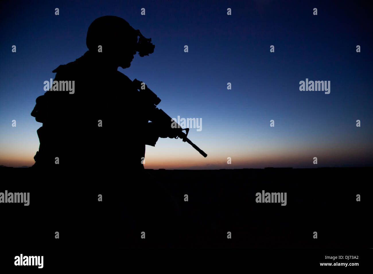 US Navy SEAL team special operations commando provides security during a night mission July 3, 2013 in Helmand province, Afghanistan. Stock Photo