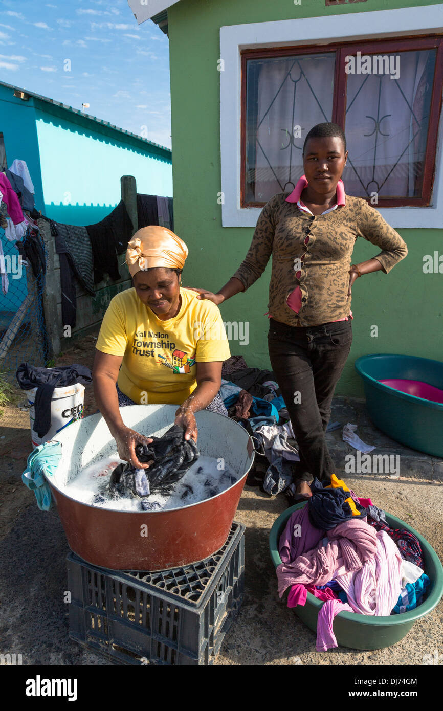 South Africa, Cape Town. Woman doing her Laundry, Wallacedene Township