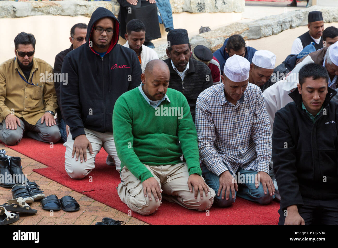 South Africa, Cape Town, District Six. Overflow Crowd Prays in the Courtyard of Al-Azhar Mosque for Noon Friday Prayers. Stock Photo