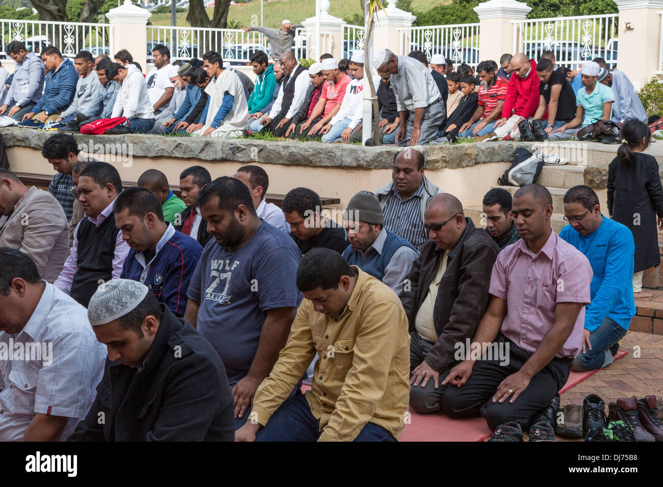 South Africa, Cape Town, District Six. Overflow Crowd Prays in the Courtyard of Al-Azhar Mosque for Noon Friday Prayers. Stock Photo