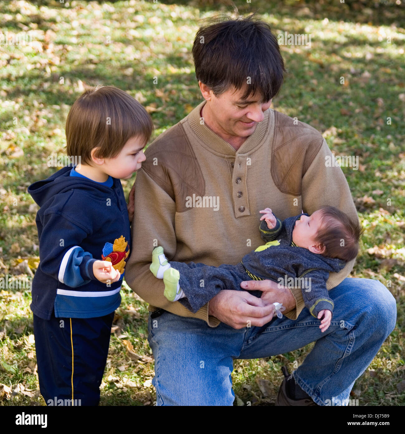 Grandfather with Two Grandsons Stock Photo