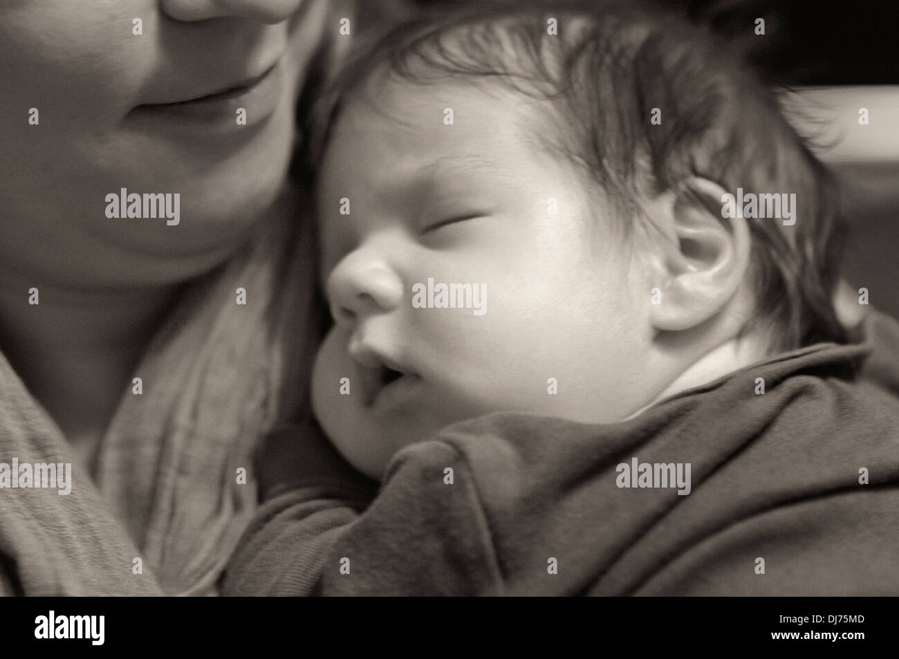 Mother Holding Her Sleeping New Baby Boy Stock Photo