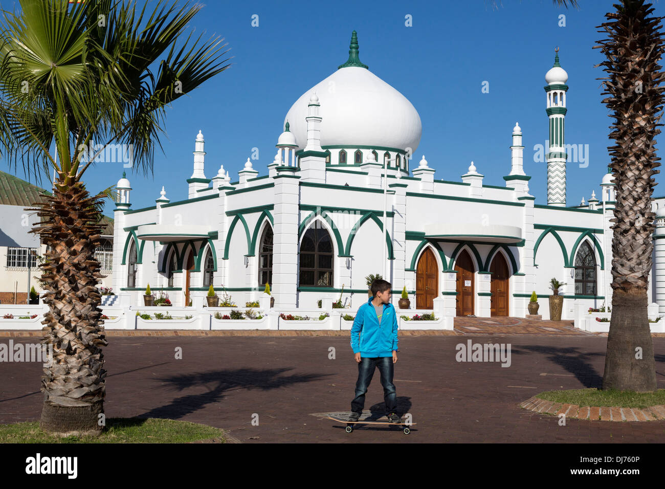 Cape Town, South Africa. Boy on a Skate Board in front of the Tomb of Maulana Abd al-Latif (died 1916). Stock Photo