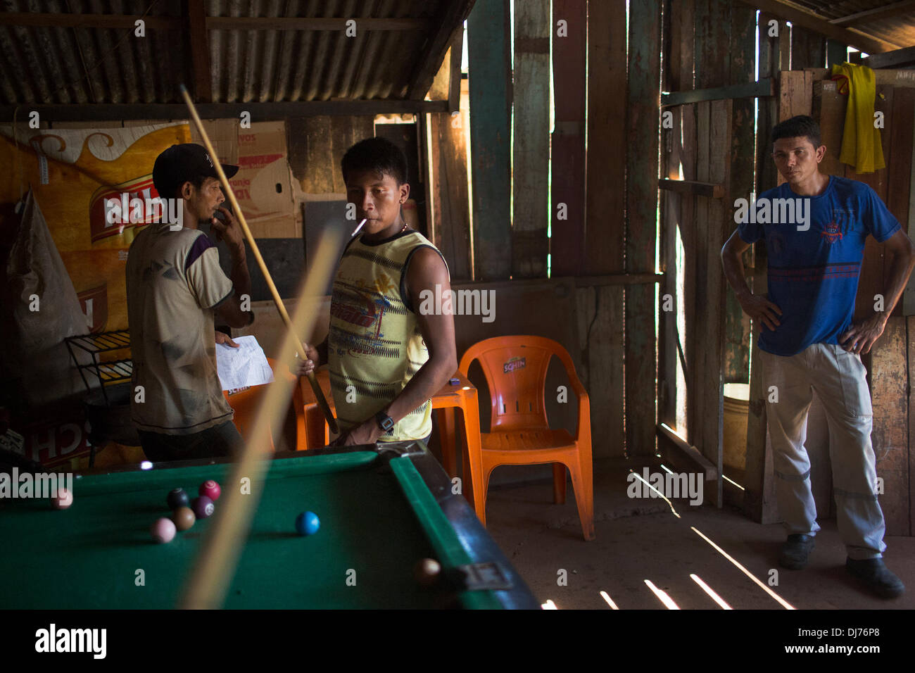 May 16, 2013 - Poti-Kro, Para, Brazil - Bekre, a young Xikrin man, plays pool with friends in an Altamira bar. Xikrin people live on the Bacaja, a tributary of the Xingu River, where construction of the Belo Monte Dam is reaching peak construction. Some scientists warn that the water level of the Bacaja will decrease precipitously due to the dam. (Credit Image: © Taylor Weidman/ZUMA Wire/ZUMAPRESS.com) Stock Photo
