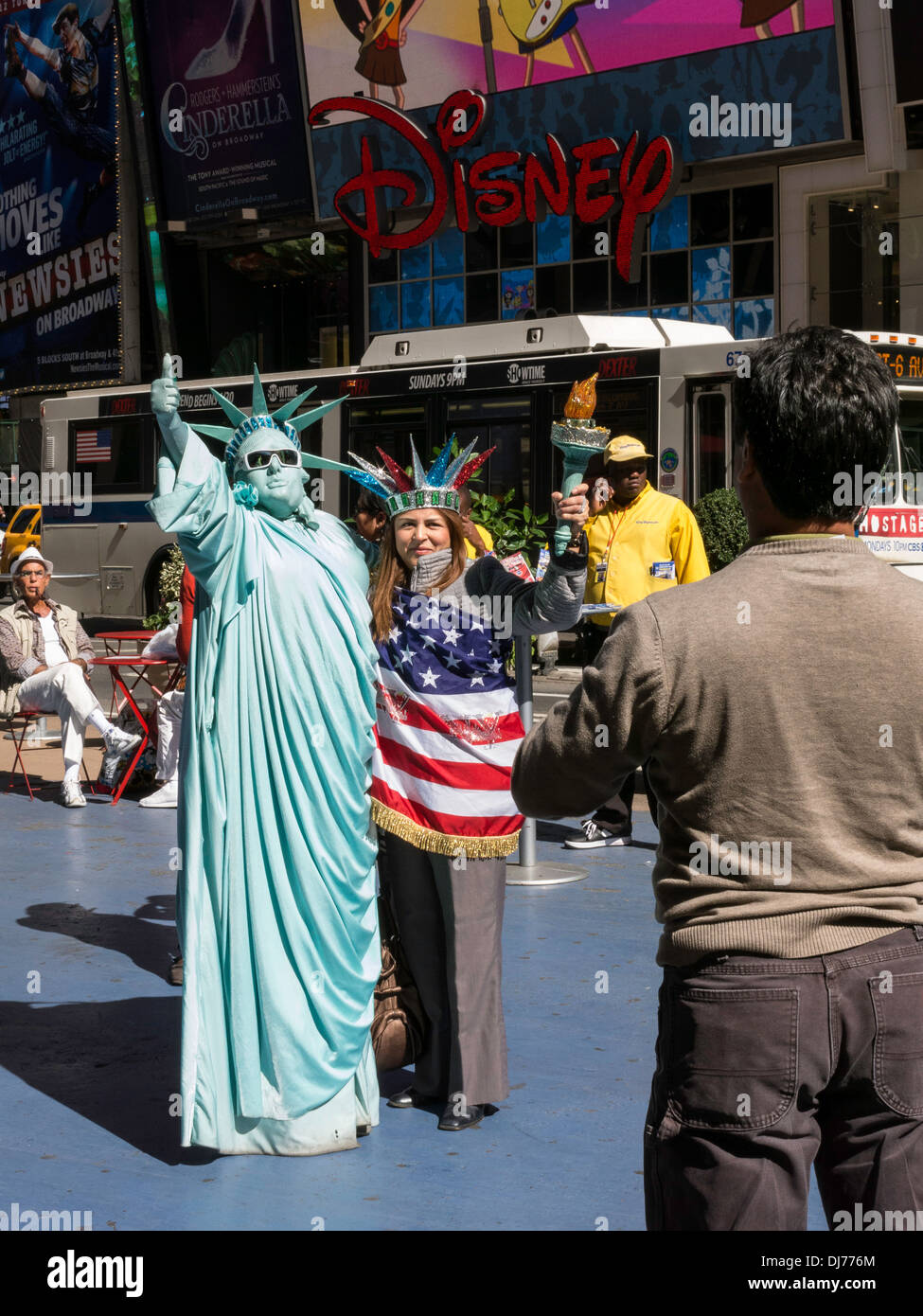 Statue of Liberty Street Artist and Woman Tourist Pose for a Photograph, Times Square , NYC, USA Stock Photo