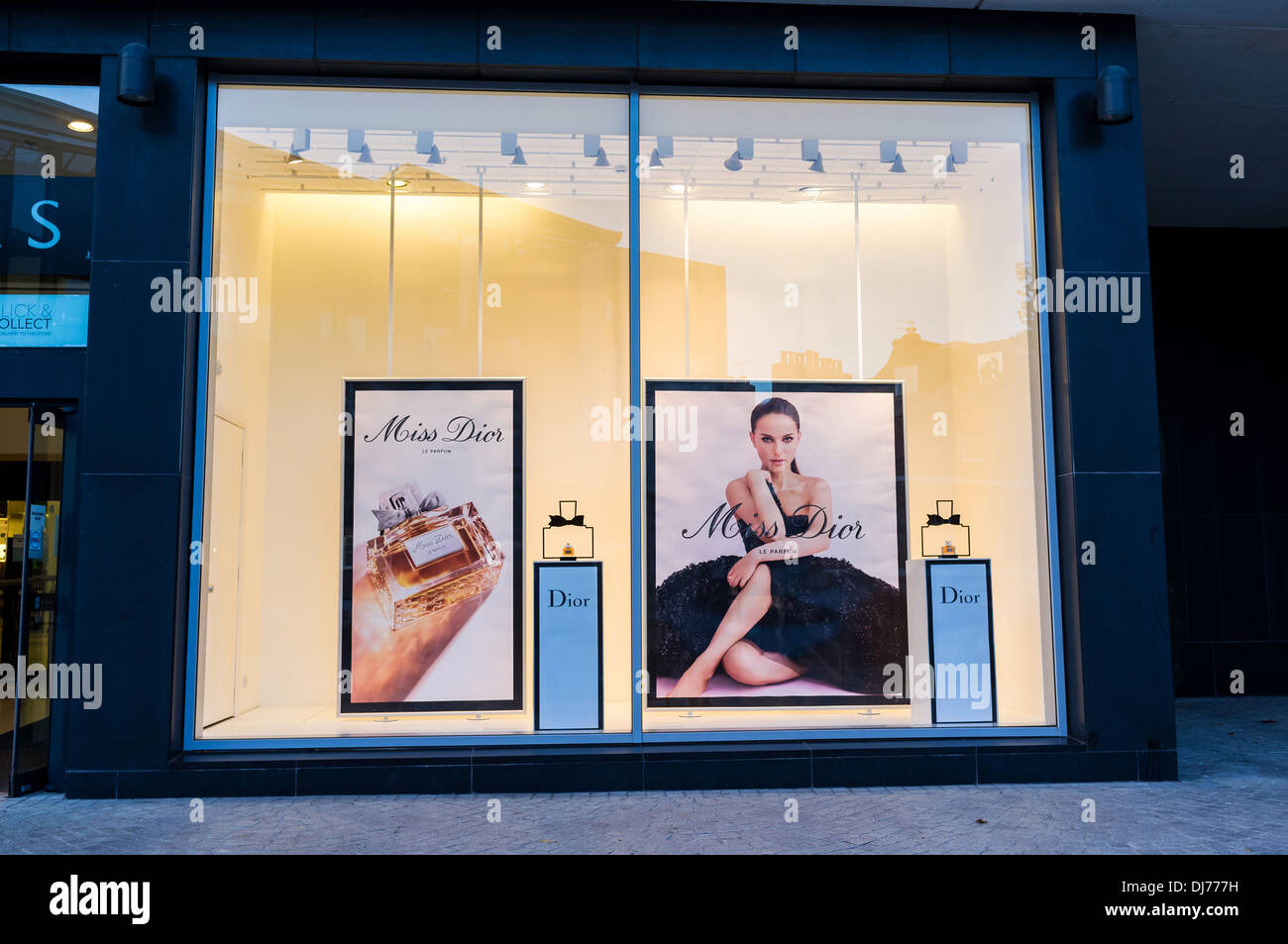 Exeter,Devon. A large show window of a high street store showing an advert featuring Natalie Portman advertising Dior perfume. Stock Photo