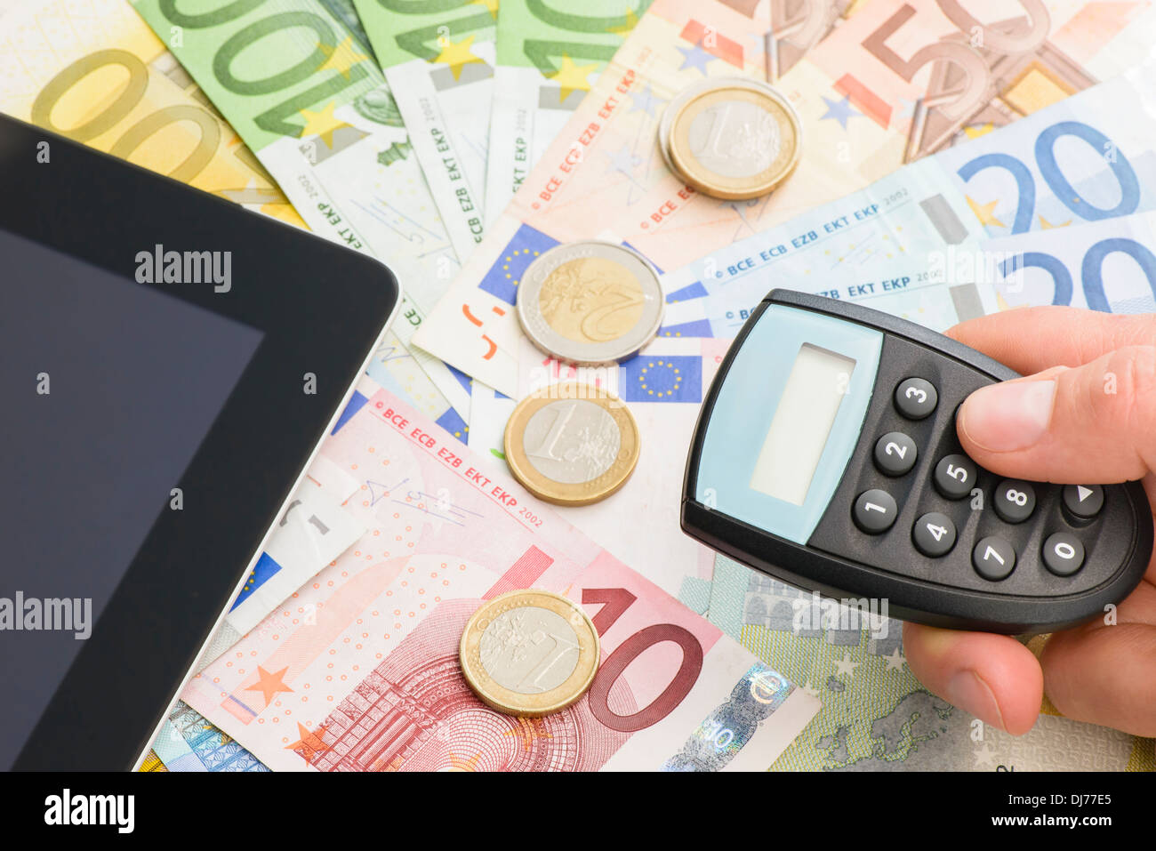 Close-up of euro currencies and internet banking device Stock Photo