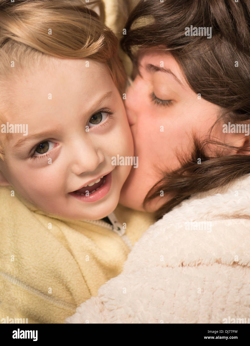 A young mother kissing her little baby Stock Photo