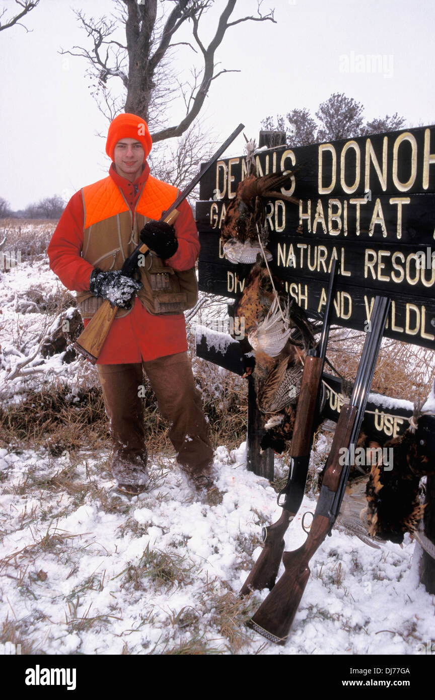 Young Upland Hunter Posing with Shotgun and Harvested Pheasants in Northern Indiana Stock Photo