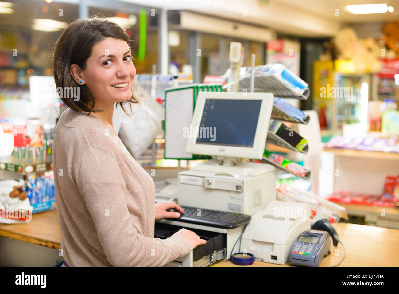 Young woman at cash register in a store Stock Photo