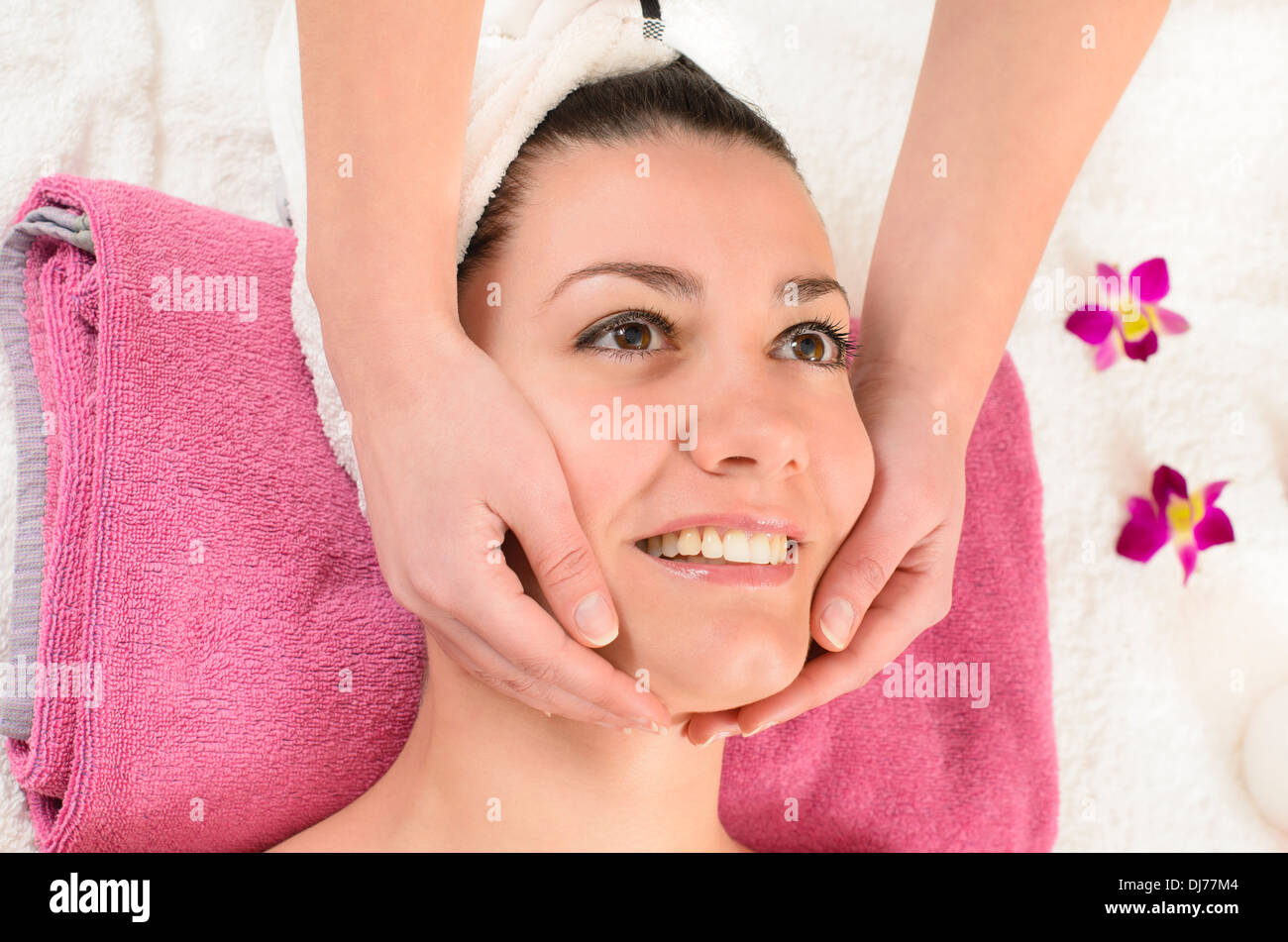 Attractive young woman getting a facial massage in the beauty spa Stock Photo